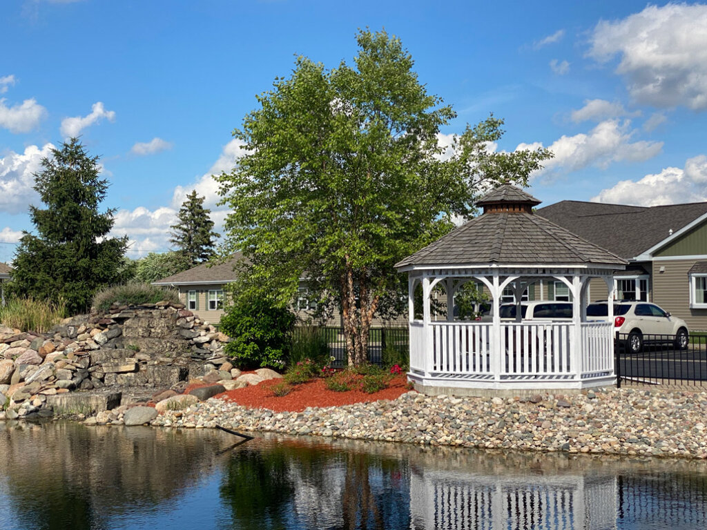 while gazebo next to lake and rocky shore at traditions of saginaw